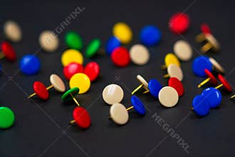 Multi-Colored Thumbtacks on Dark Background