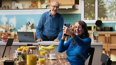 Aged wife takes photos of her with the smartphone camera