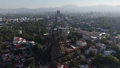 Rotating drone perspective on urban development and cranes in Mexico City