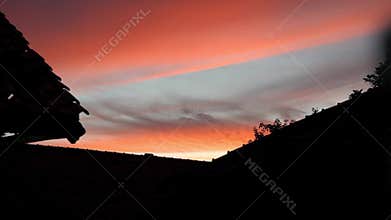sunset followed by the color of the sky clouds turning red