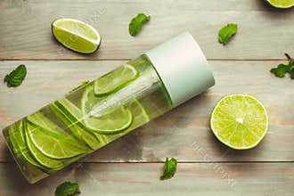 Health care, fitness, healthy nutrition diet concept. Fresh cool lemon mint infused water, cocktail, detox drink, lemonade in a