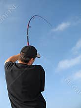 Fisherman fighting a fish