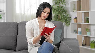 Woman at home writing in agenda