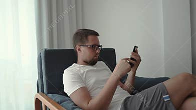 Casual guy taking time to relax at home.