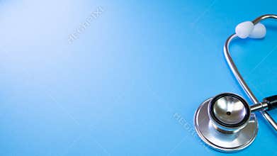 Medicine stethoscope heart for doctor checkup on table in hospital or pharmacy at blue background