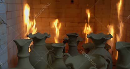 Pushcart full of clay jugs enters in to oven.