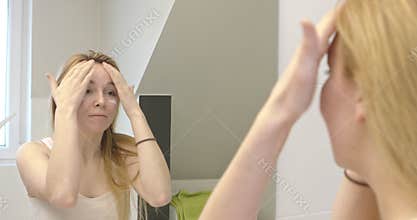 Woman moisturizing her face.