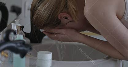 Splashing water on face