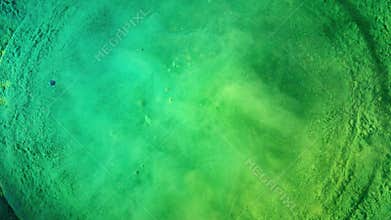 Bass loudspeaker throws green powder in the air, super slow motion shot