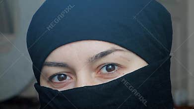 Portrait of a beautiful arab girl. An Islamic woman in a hijab looks into the camera.