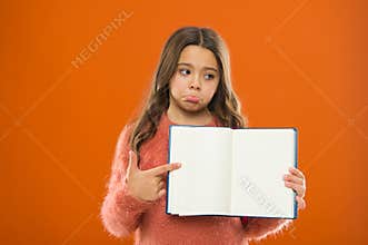 Sad news. Girl hold book orange background. Child show open pages of book or notepad. Book store concept. Free books