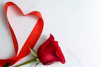 Heart shape made of red ribbon on white wooden Background. copy space - Valentines and 8 March Mother Women's Day concept
