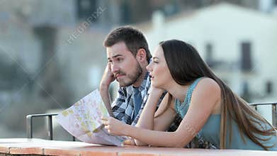 Bored couple of tourists in a town on vacation