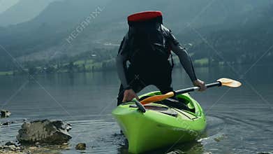 Kayaking on the scenic mountain lake.