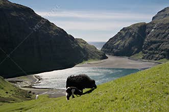 Amphitheatre shaped valley with beautiful bay surrounded by layer-cake mountains.