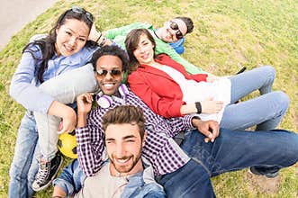 Multiracial best friends taking selfie at meadow picnic - Happy friendship fun concept with young people millenials having fun