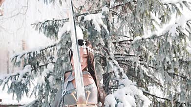 Charming attractive girl with long straight black hair poses for camera in fantasy style. warlike elegant lady with