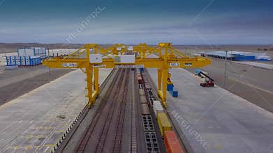 Khorgos Gateway Dryport, Kazakhstan - October 16, 2018: A bridge crane lifts the container for loading onto a railway