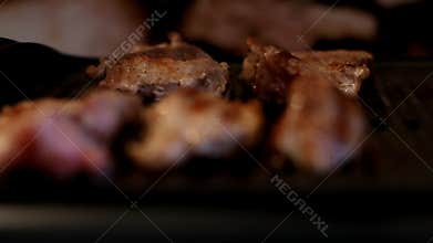Steak frying. Pork meat on grill. Chef cooking. Fresh meat. Unhealthy food. BBQ