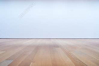 Blank white wall and hardwood floor in art gallery