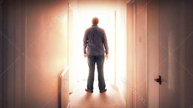 Man walks through door into bright light
