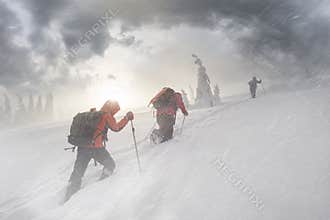 Climbers in mountain snowfall