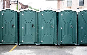 Row of Green Portable Toilets
