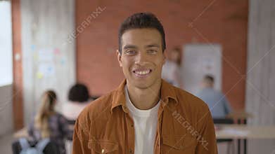 Happy successful student guy. portrait close-up. a man of mixed race in the background of the audience during a lecture