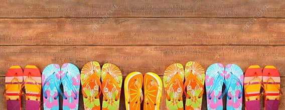 Brightly colored flip-flops on wood