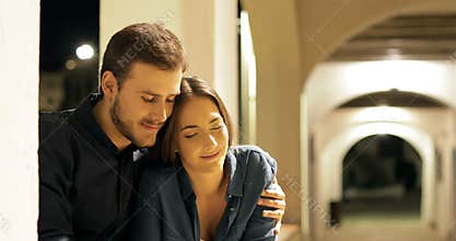 Couple in love sitting in a town the night