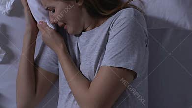 Crying pregnant lady lying in bed, single mother, unwanted pregnancy, depression