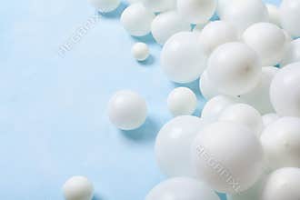 Pastel blue table with white balloons. Party or birthday background