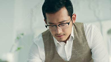Asian architect working on a sketch