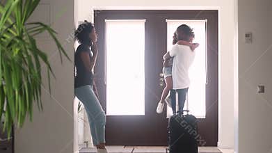 African dad talking to sad child in hallway leaving family