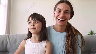 Happy mother and cute kid daughter make distant online call