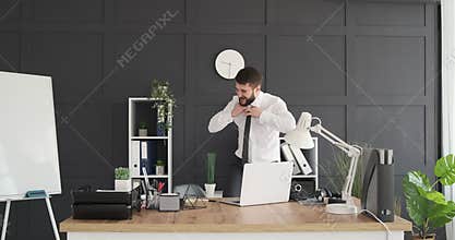 Crazy businessman dancing at office