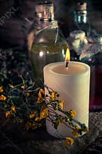 A witchery stuff: multiple tincture bottles, bunches of dry healthy herbs, stack of ancient ritual books, amulets, candles...