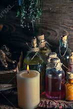 A witchery stuff: multiple tincture bottles, bunches of dry healthy herbs, stack of ancient ritual books, amulets, candles...