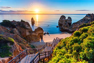 Camilo Beach &#x28;Praia do Camilo&#x29; at Algarve, Portugal with turquoise sea in background. Wooden footbridge to beach Praia