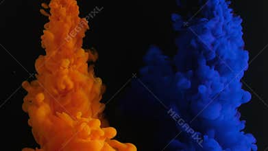 Paint stream in water, colored ink cloud spreading on black background, abstract background, video