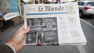 Man reading news about Brexit in French press kiosk