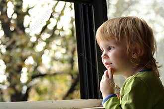 Little girl looking out window