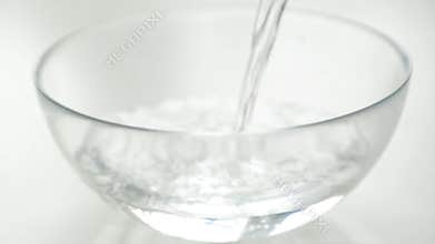 Pouring clean water into a glass bowl