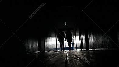 Two lovers in a dark corridor