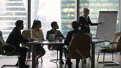 Female presenter giving lecture presentation in modern office