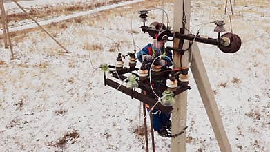 Electrician repairman working on tower at the electric station