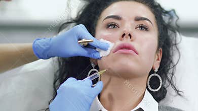 Doctor makes facial botox injection