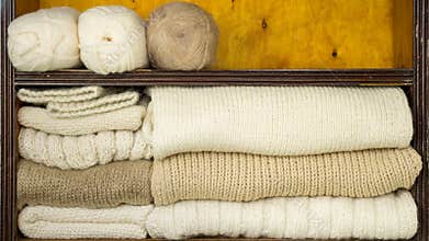 Filling of shelves by balls of wool, knitting needles, finished woollen fabrics