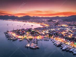 Aerial view of boats and beautiful city at night in Marmaris