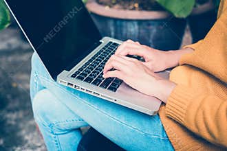 Business Technology Concepts - Digital lifestyle working outside office. Woman hands typing laptop computer with blank screen.